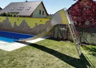 Private water slide with ladder, model "BANÁN" made of stainless steel.
