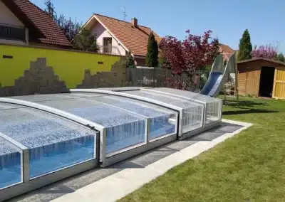 Roofed pool with stainless steel water slide.